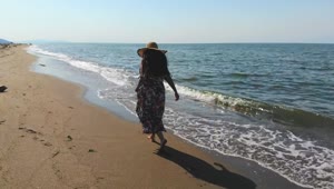 Stock Footage Woman With A Hat Walking On An Empty Beach Live Wallpaper Free
