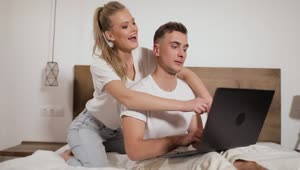 Stock Footage Woman Hugs Man Working On Laptop In Bed Live Wallpaper Free