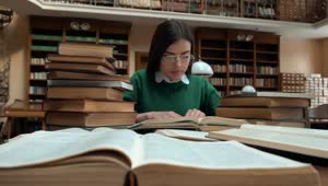 Stock Footage Woman Researching In Library Sits Back With Idea Live Wallpaper Free