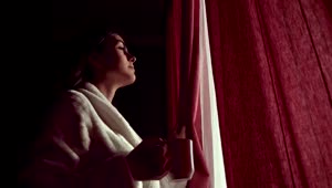 Stock Footage Woman Sips Coffee And Looks Through Curtains In Lockdown Live Wallpaper Free