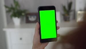 Stock Footage Woman Holding Greenscreen Mobile Phone Taps Screen Live Wallpaper Free