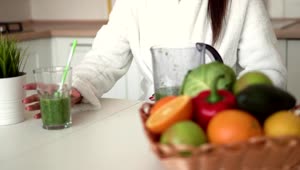 Stock Footage Woman Enjoys Healthy Green Smoothie In Kitchen Live Wallpaper Free