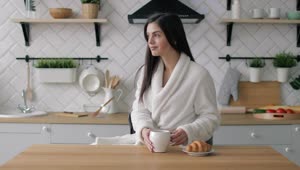 Stock Footage Woman Enjoys Morning Coffee In Urban Kitchen Live Wallpaper Free