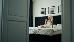 Stock Footage Woman Enjoys Coffee On Bed After Shower Live Wallpaper Free
