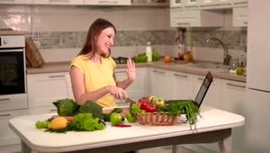 Stock Footage Woman Prepares Dinner While Video Chatting On Laptop Live Wallpaper Free