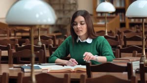 Stock Footage Woman Focused On Research In Library With Books Live Wallpaper Free