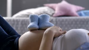 Stock Footage Woman Laying Down With Baby Shoes Live Wallpaper Free
