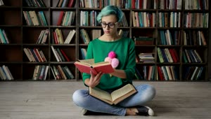 Stock Footage Woman With Glasses Reading In The Library Live Wallpaper Free