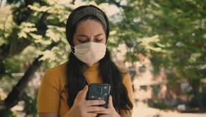 Stock Footage Woman In A Mask Sends Messages On Her Smart Phone Live Wallpaper Free