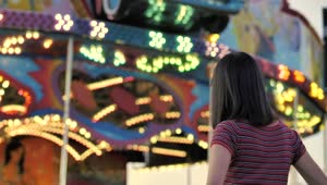 Stock Footage Woman From The Back Looking Towards A Mechanical Game With Live Wallpaper Free