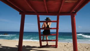 Stock Footage Woman Sitting At Lifeguard Station Live Wallpaper Free