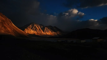 a mountain range at night 4k jj wallpaper