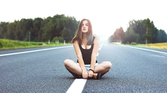 girl sitting on road wallpaper