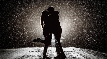 couple kissing in snow night wallpaper