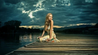 girl alone sitting near lake wallpaper