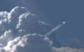 Plane Soaring Over Clouds
