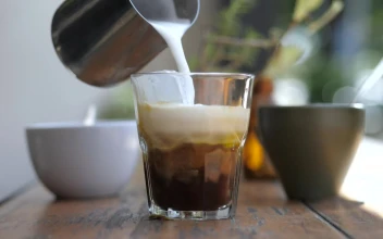Stock Video A Barista Preparing Coffee With Milk And Ice for PC