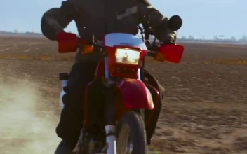 Stock Video A Biker Riding Through The Desert for PC