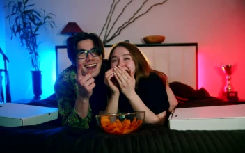 Stock Video A Boy And A Girl Laughing While Watching Television for PC