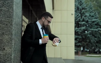 Stock Video A Business Man Is Eating While Walking for PC