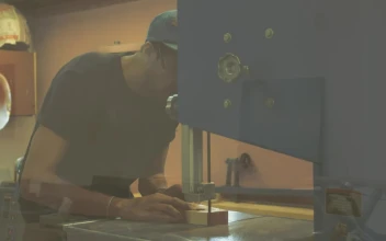 Stock Video A Carpenter Using A Sawing Machine for PC