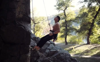 Stock Video A Climber Testing The Ropes On The Rock for PC