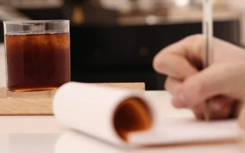Stock Video A Coffee Drinker Taking Notes for PC