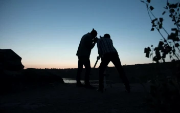 Stock Video A Couple Of Friends Stargazing Using The Telescope for PC