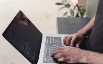 Stock Video A Developer Typing On A Laptop Top View for PC