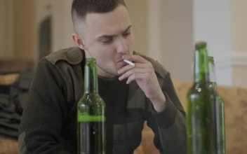 Stock Video Addict Sits On Sofa Smoking And Drinking for PC