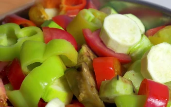 Stock Video Adding Sliced Vegetables To A Dish for PC