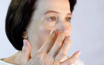 Stock Video Adult Woman Gently Putting A Cream On Her Face for PC