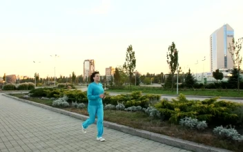 Stock Video Adult Woman Jogging Through A Large Garden  Larg for PC