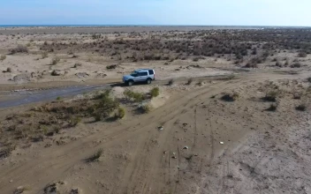 Stock Video Aerial Following Of A Car Passing Through The Water for PC