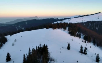 Stock Video Aerial Pan Shot Over A Winter Mountain Rage for PC