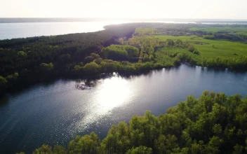 Stock Video Aerial Shot Of A River Crossing The Field In Spring for PC