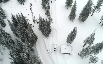 Stock Video Aerial Shot Of A Ski Station With People Practicing for PC