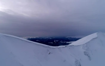 Stock Video Aerial Shot Of The Top Of A Snow Covered Mountain for PC