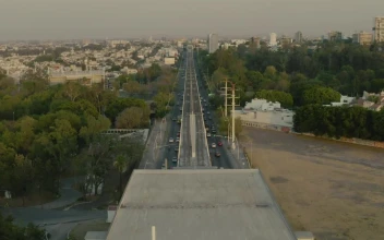 Stock Video Aerial Tour Over The Train Tracks That Cross A City for PC