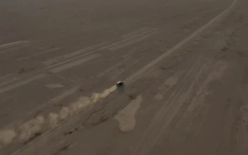 Stock Video Aerial View Of A Pickup Truck Traveling Through A Desert for PC