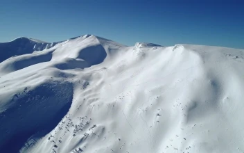 Stock Video Aerial View Of A Snow Covered Mountain Landscape for PC