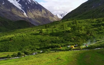 Stock Video Aerial View Of Campsite On Creek In Mountain Valley for PC