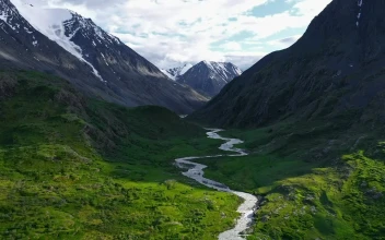 Stock Video Aerial View Of Lush River Valley And Snowy Mountains for PC
