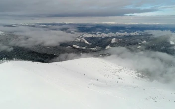 Stock Video Afar Aerial Shot Of A Ski Station In A Mountain for PC