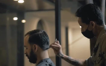 Stock Video Barber Cutting Into A Mans Hair For PC