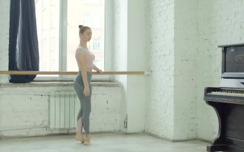 Stock Video Ballet Dancer Warming Up Holding A Pole For PC