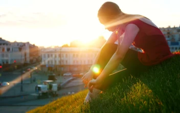Stock Video Ballet Dancer Adjusting Her Slippers On The Grass For PC
