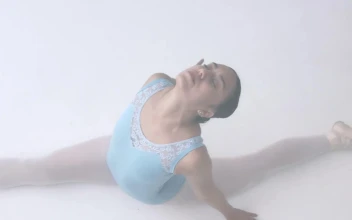 Stock Video Ballerina While Stretching On The Floor For PC
