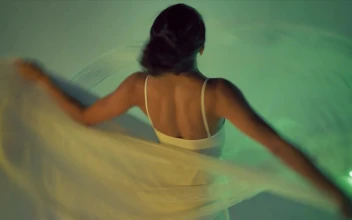 Stock Video Ballerina Dancing Artistically Wearing A White Dress For PC