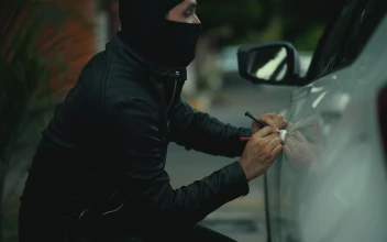 Stock Video Balaclava Assailant Steals Computer From Car For PC